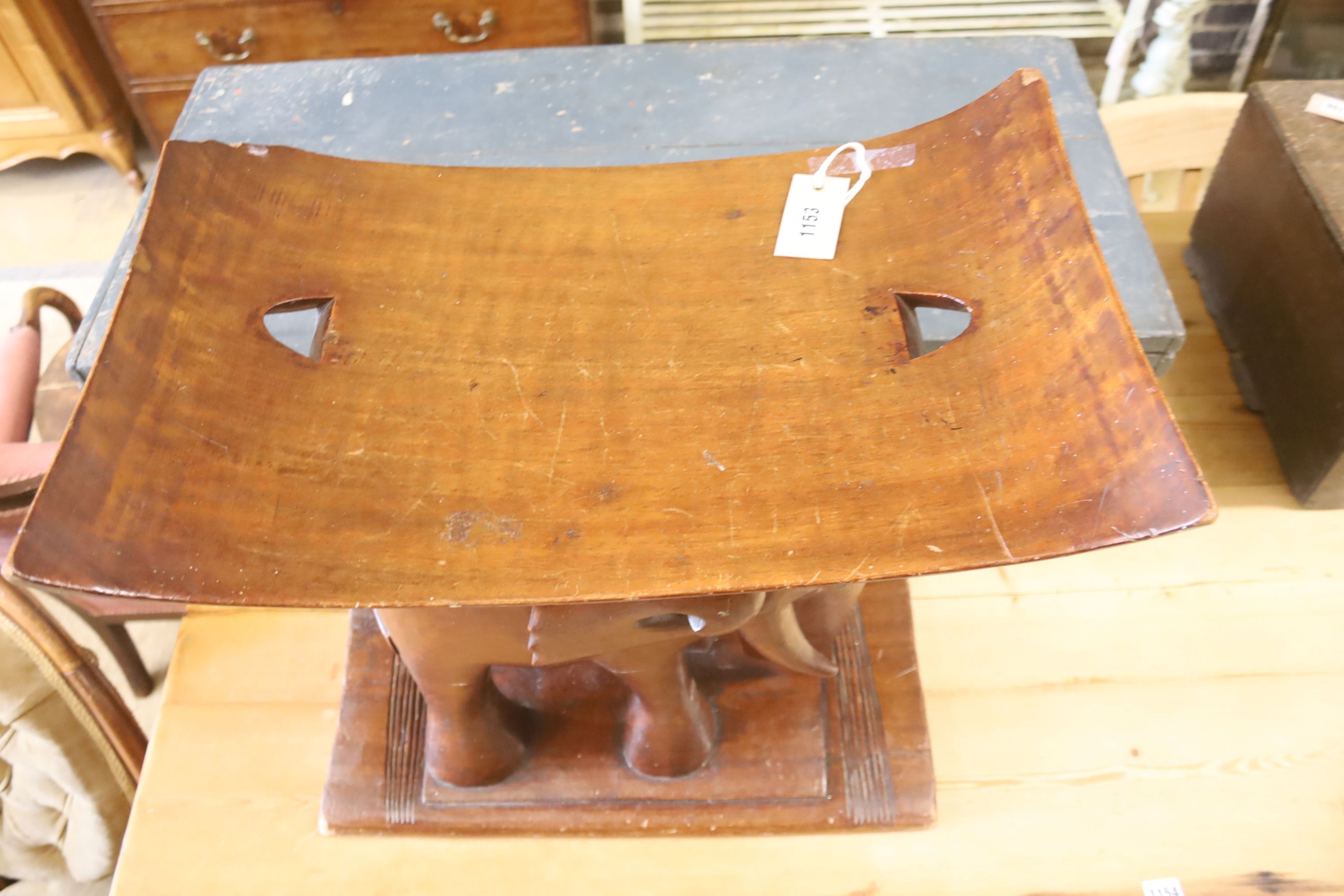 An Ashanti carved elephant stool, width 55cm, depth 26cm, height 58cm